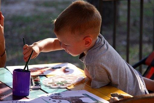 Kid painting canvas